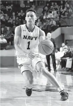  ?? PAUL W. GILLESPIE/BALTIMORE SUN MEDIA GROUP ?? Navy's John Carter Jr., who led the Midshipmen with 26 points, brings the ball upcourt in the first half against Army in front of a crowd of 5,448.
