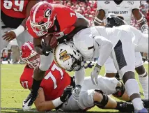  ?? BOB ANDRES / ROBERT.ANDRES@AJC.COM ?? D’Andre Swift scores the Bulldogs’ first touchdown during the first quarter. Swift scored twice and had 67 of the Bulldogs’ 269 rushing yards.