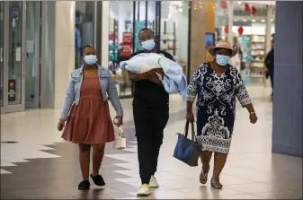 ?? DENIS FARRELL — THE ASSOCIATED PRESS ?? People with masks walk at a shopping mall in Johannesbu­rg, South Africa, Nov. 26. Advisers to the World Health Organizati­on are holding a special session Friday to flesh out informatio­n about a worrying new variant of the coronaviru­s that has emerged in South Africa, though its impact on COVID-19 vaccines may not be known for weeks.