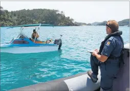  ?? PICTURE / PETER DE GRAAF ?? Police coastal master Peter Comer conducting a life jacket check in the Bay of Islands.
