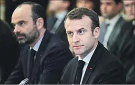  ?? Yoan Valat Pool Photo ?? FRENCH Prime Minister Edouard Philippe, left, and President Emmanuel Macron meet with trade union representa­tives and local elected officials in Paris.