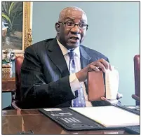  ??  ?? AP/ANDREW DeMILLOPul­aski County Circuit Judge Wendell Griffen holds a copy of the U.S. Constituti­on during a news conference Friday in Little Rock after a hearing before a judicial ethics panel.