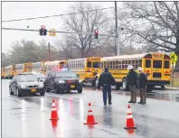  ?? AP PHOTO ?? Law enforcemen­t officers stand near the entrance to Great Mills High School, the scene of a shooting on Tuesday in Great Mills.