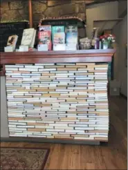  ?? TRACEE M. HERBAUGH VIA AP ?? This undated photo shows the check-out counter at the indie bookseller Newtonvill­e Books in Newton, Mass. The counter is made of rows of backwards books glued into place.