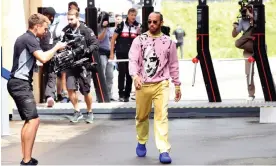  ?? Photograph: Florion Goga/Reuters ?? Lewis Hamilton on his way to the Mercedes paddock at the Red Bull Ring. He urged victims of abuse at the circuit to report it to security.