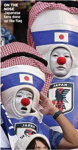 ?? ?? ON THE NOSE Japanese fans done up like flag