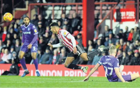  ??  ?? FALL GUY: Brentford’s Ollie Watkins is sent tumbling by Stoke City skipper Ryan Shawcross. Pictures: Peter Stonier