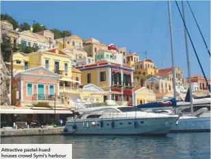  ??  ?? Attractive pastel-hued houses crowd Symi’s harbour