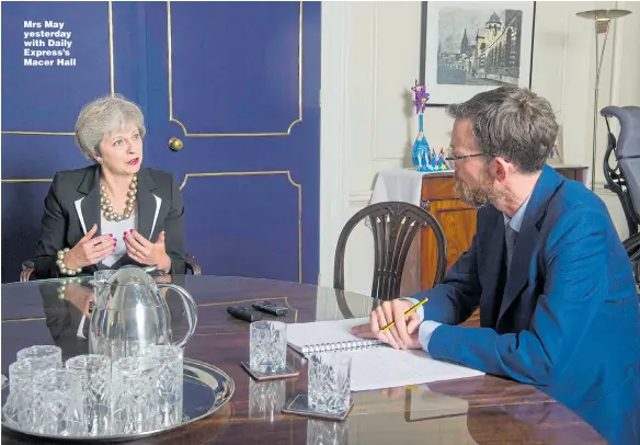 ?? Picture: TIM CLARKE ?? Mrs May yesterday with Daily Express’s Macer Hall