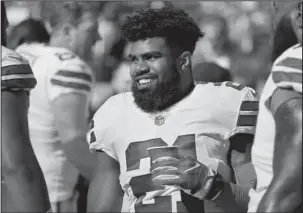  ?? The Associated Press ?? ALL SMILES: Dallas Cowboys running back Ezekiel Elliott smiles on the sideline after scoring a touchdown during the second half of an Oct. 22 game against the San Francisco 49ers in Santa Clara, Calif. A federal appeals court says Elliott can play in...