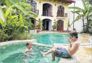  ?? Katie Quirk ?? IT’S GOOD to stay in and go for a swim such as Liam and Reid did at Hotel la Polvora in Granada, Nicaragua.