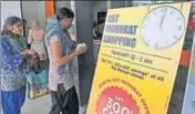  ?? AFP ?? Customers walk into a store next to a promotiona­l sale poster ahead of the introducti­on of the Goods and Services Tax at a shopping mall in Hyderabad on Friday.