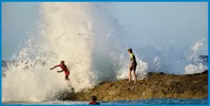  ??  ?? Young swimmers in the swell at Snapper Rocks generated by Tropical Cyclone Oma. Picture: Mark Furler