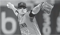  ?? JULIE JACOBSON/AP ?? Diamondbac­ks pitcher Zack Godley delivers against the Mets during the first inning Friday in New York.