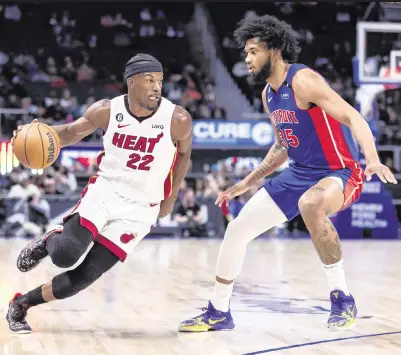  ?? ALLISON FARRAND USA TODAY Sports ?? The Heat’s Jimmy Butler drives to the basket against Pistons forward Marvin Bagley III in the first quarter at Little Caesars Arena. Butler scored 26 points and added 10 assists in Miami’s victory that was much needed in the playoff race with nine games left.