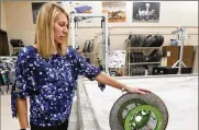  ?? MIKE CARDEW / AKRON BEACON JOURNAL ?? Heather Oravec, a University of Akron research associate professor stationed at the NASA Glenn Research Center, rolls a nickel titanium shape memory alloy tire on a simulated off-world surface in the Simulated Lunar Operations Lab in Cleveland in 2019.