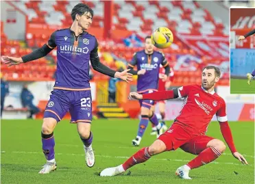  ??  ?? Aberdeen’s Niall Mcginn and United’s Neil Harkes both have their eyes on the ball