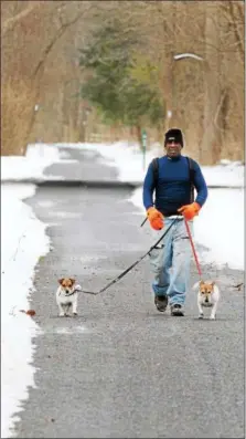  ?? DIGITAL FIRST MEDIA FILE PHOTO ?? Walking with a friend, or in this case with two four-legged friends, is good motivation to start the new year on the right foot.