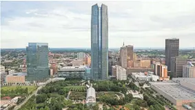  ?? THE OKLAHOMAN FILE ?? Looking north at downtown Oklahoma City, you can see the BOK Park Building and Devon Energy Tower and Myriad Botanical Gardens in the foreground. The gardens offer the perfect spot for a relaxing stroll.