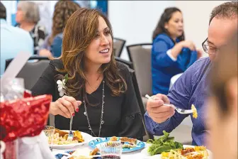  ?? ?? (Left) Tara Gordon, a teacher at Live Oak Elementary, speaks with her colleagues during the SCV Education Foundation’s Teacher Tribute Event at the Canyon Country Community Center in Canyon Country Friday. Gordon was awarded a medal for her hard work and commitment to educating the youth. (Right) Educators from all the school districts in Santa Clarita gather for the SCV Education Foundation’s Teacher Tribute.