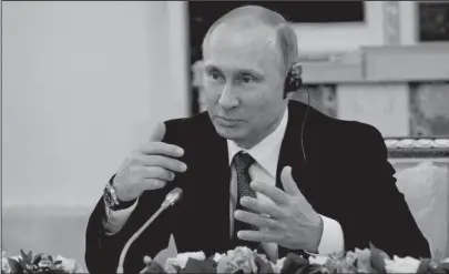  ?? The Associated Press ?? PUTIN: Russian President Vladimir Putin speaks at a meeting with heads of internatio­nal news agencies Thursday at the St. Petersburg Internatio­nal Economic Forum in St. Petersburg, Russia.