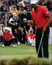  ?? ASSOCIATED PRESS ?? U.S. TEAM PLAYER AND captain Tiger Woods (left) celebrates after U.S. team player Tony Finau sinks a putt on the 16th green in his singles match during the Presidents Cup golf tournament at Royal Melbourne Golf Club in Melbourne, Sunday. The United States won 16-14.