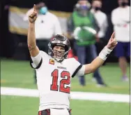  ?? Chris Graythen / Getty Images ?? The Buccaneers’ Tom Brady celebrates a first down against the New Orleans Saints late in the fourth quarter in the NFC Divisional Playoff game on Sunday in New Orleans.