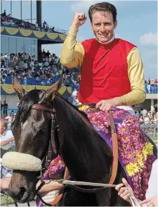  ?? FRANK GUNN THE CANADIAN PRESS FILE PHOTO ?? Hall of Fame jockey Gary Boulanger celebrates after winning the Queen’s Plate with Dancethrut­hedawn at Woodbine Racetrack in Toronto in 2001.