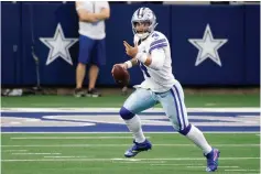  ?? AP Photo/Ron Jenkins, File ?? ■ Dallas Cowboys quarterbac­k Dak Prescott (4) scrambles out of the pocket before throwing a pass in the second half of an NFL football game against the Cleveland Browns Oct. 4, 2020, in Arlington, Texas. It’s a potential problem for the Cowboys if they can’t get a long-term deal with Prescott, which would cause his cap charge to hit $37 million with another franchise tag after being around $31 million last year.