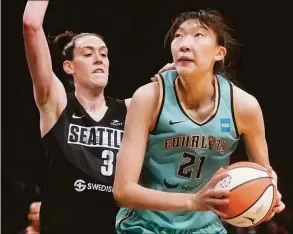  ?? Mary Altaffer / Associated Press ?? New York Liberty center Han Xu (21) drives against Seattle Storm forward Breanna Stewart, left, during the second half of a WNBA game on June 19.
