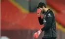  ?? Photograph: Simon Stacpoole/Offside/Getty ?? Alisson can’t believe it after he gifted Manchester City two chances which they took to go from 1-1 to 3-1 in front.