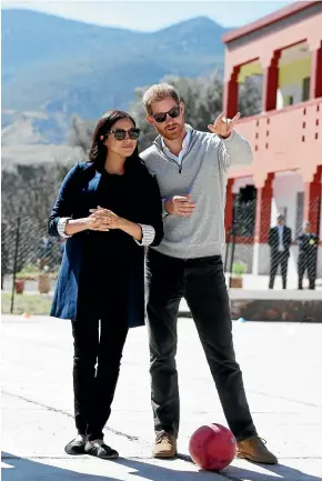  ?? AP ?? Prince Harry and Meghan, Duchess of Sussex, watch children playing football at a school in the town of Asni, in the Atlas mountains of Morocco.