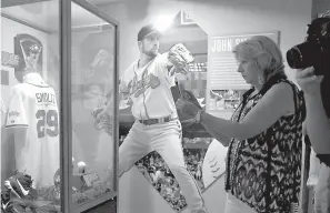  ?? AP Photo/Mike Groll, File ?? ■ Fans visit a John Smoltz exhibit July 25, 2015, at the Baseball Hall of Fame in Cooperstow­n, N.Y. This weekend brings the latest crop of inductees into the Baseball Hall of Fame, the ultimate repository of the game’s yesterdays, Vladimir Guerrero,...