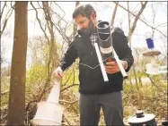  ??  ?? Scientist John Shepard, of the Connecticu­t Agricultur­al Experiment Station in New Haven, puts out a variety of mosquito traps on Land Conservati­on Trust property in Milford on Wednesday.