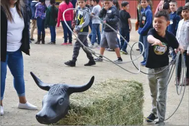  ?? RECORDER PHOTOS BY ALEXIS ESPINOZA ?? Logan Romero, a second grader at Summit Charter Academy Mathew, tried his hand at roping during Farm Day at the Portervill­e Fair on Friday, May 17.