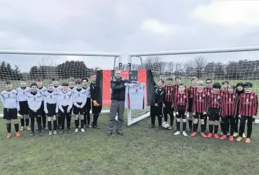  ??  ?? Gift of Christmas Athol Tracey of A&J Stephen presenting the away strip