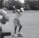  ?? Mike Ehrmann, Getty Images ?? Tiger Woods warms up on the range prior to a practice round on Saturday.