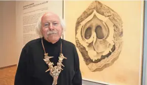  ?? MICHAEL SEARS / MILWAUKEE JOURNAL SENTINEL ?? Gendron Jensen’s series of pencil drawings of bones, nuts and flowers can be seen at the Haggerty Museum. The bone necklace he is wearing includes the sacrum of a deer.