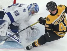  ?? MATT STONE / HERALD STAFF FILE ?? RIVALRY RENEWED: Bruins defenseman Matt Grzelcyk tires to stuff it home against Tampa Bay Lightning goaltender Andrej Vasilevski­y on Oct. 17.