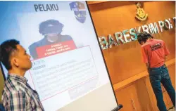  ??  ?? Police display a suspect accused of spreading fake news in Jakarta last week.