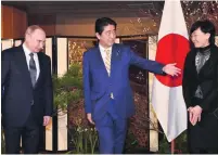  ?? Kazuhiro Nogi / AP Photo ?? Russian president Vladimir Putin, left, with Japanese prime minister Shinzo Abe and his wife, Akie.