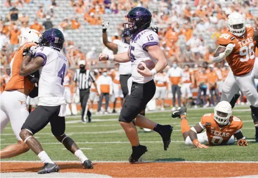  ?? ERIC GAY/AP ?? TCU quarterbac­k Max Duggan (15) runs for a touchdown against Texas in the first half. The Horned Frogs scored a road upset of the No. 9 Longhorns on Saturday.