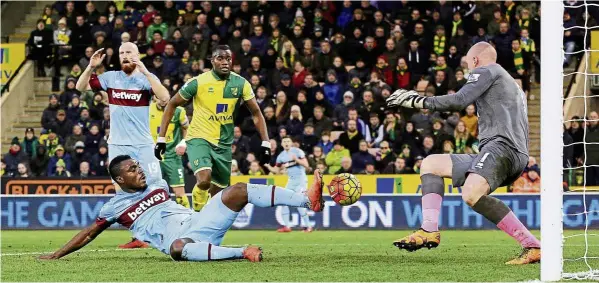  ?? — reuters ?? rough and tumble: West Ham’s Emmanuel Emenike has his shot saved by Norwich goalkeeper John ruddy at Carrow road onsaturday.