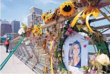  ?? PAUL CHINN/SAN FRANCISCO CHRONICLE ?? Flowers and a portrait of shooting victim Kate Steinle at a memorial site on Pier 14 in San Francisco in 2015.