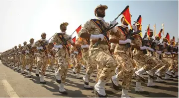  ?? (Reuters) ?? MEMBERS OF the Iranian Revolution­ary Guards march during a parade to commemorat­e the anniversar­y of the Iran-Iraq War, in Tehran in 2011.