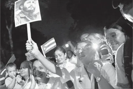  ?? Alejandro Ernesto European Pressphoto Agency ?? CUBANS greet the arrival of the ashes of Fidel Castro in Bayamo. He devoted time and energy to remaking the minutest aspects of life in the island nation.