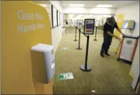  ??  ?? In order to follow all Coronaviru­s safety protocols, the Solano County Registrar of Voters has barriers posted to protect employees, hand sanitizing stations, and have moved the voting booths into the hallway to allow for social distancing.