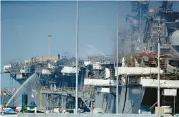  ?? GREGORY BULL/AP 2020 ?? Fire crews in San Diego spray water on the burning USS Bonhomme Richard. Navy leaders discipline­d more than 20 senior officers and sailors in the incident.