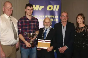  ??  ?? Athlete of the year Michael Bowler (second left) with Seamus Darcy (Mr Oil), Nicky Cowman (President, Athletics Wexford), Paddy Morgan (Chairman, Athletics Wexford), and Marie Mooney (Mr Oil).