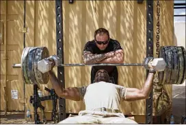  ?? MAYA ALLERUZZO / ASSOCIATED PRESS ?? U.S. soldiers from the 82nd Airborne Division lift weights on a base east of Mosul last month. The U.S. and Iraq are in talks to keep American troops in Iraq after the fight against the Islamic State group is over, officials said.